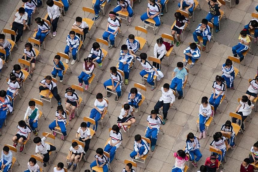 Students from different classes attend an outdoor joint lesson outside a school building in Guangzhou, Guangdong province on April 18, 2014.&nbsp;China's high-pressure, exam-driven education system is responsible for the vast majority of suicides by 