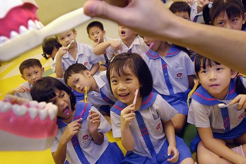 Kindergarten students in PCF Paya Lebar Education&nbsp;Centre get a lesson on the correct way to&nbsp;brush their teeth by a dental therapist&nbsp;from the Health Promotion Board. Bad teeth is an increasing problem among young children here, with at 