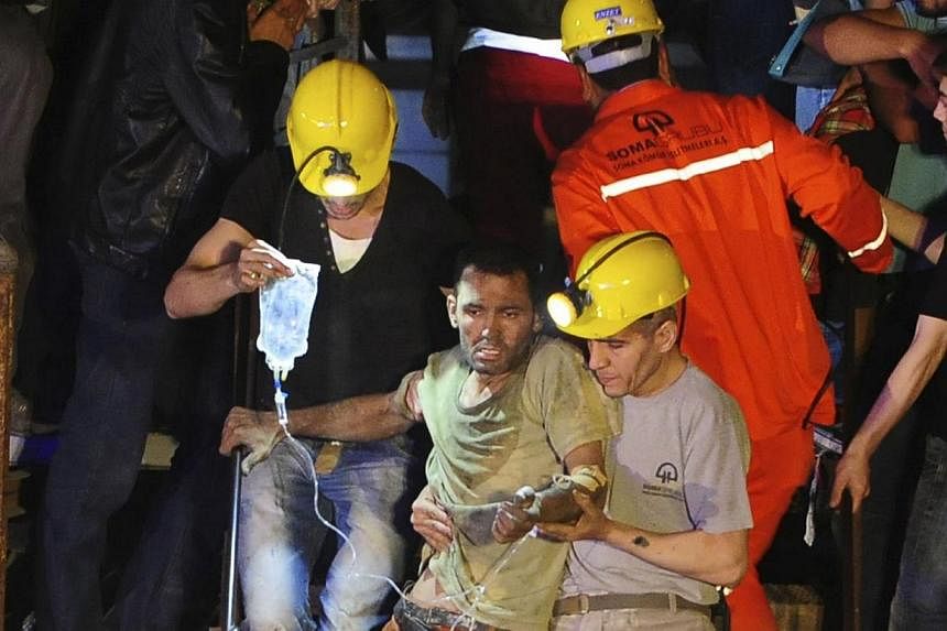 An injured miner is carried to an ambulance after being rescued from a coal mine he was trapped in, in Soma, a district in Turkey's western province of Manisa, on May 13, 2014. More than 200 people were killed after an explosion on Tuesday at a coal 