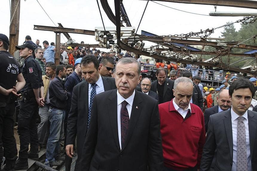 Turkey's Prime Minister Tayyip Erdogan (centre) visits the coal mine accident site in Soma, a district in Turkey's western province of Manisa, on May 14, 2014. -- PHOTO: REUTERS&nbsp;