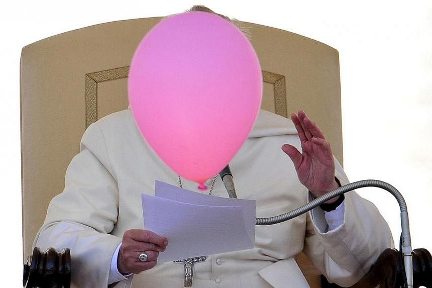 A balloon flies past Pope Francis during his general audience in St Peter's Square at the Vatican on May 14, 2014.&nbsp;-- PHOTO: AFP
