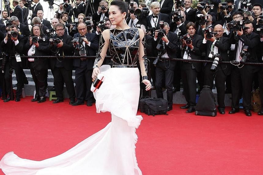 Zhang Ziyi, in a geometric, cascading Stephane Rolland dress, is ready to rock a space-age opera. -- PHOTO: AFP