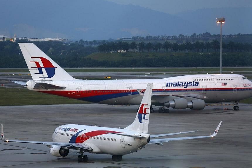 Malaysia Airlines aircrafts taxi on the runway at Kuala Lumpur International Airport in Sepang outside Kuala Lumpur May 13, 2014.&nbsp;Malaysia Airlines said one of its planes was grounded on Thursday, May 15, 2014, after a service vehicle struck the