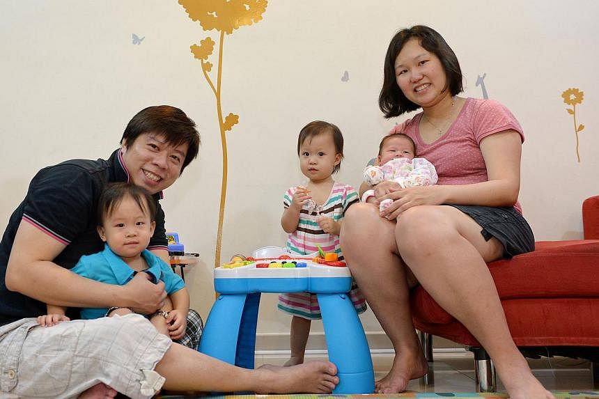 Roger Kok and his wife, Magdalene Tan, with their twins, Natalie (in stripes) and Maximilian (in blue), both 17 months and their youngest child, seven-week-old Iris. In our society, families come in many forms, and the same individual's family can lo