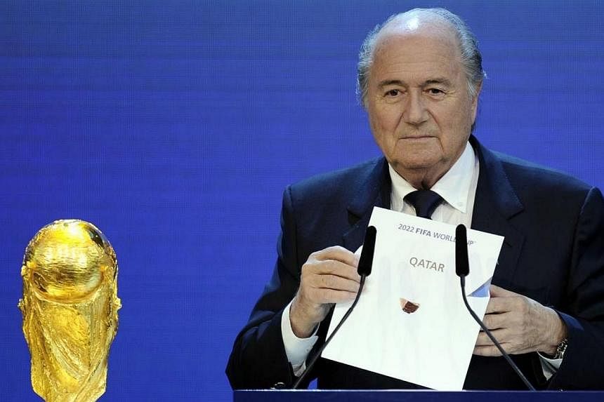 Fifa President Sepp Blatter holding up the name of Qatar during the official announcement of the 2022 World Cup host country at the Fifa headquarters in Zurich&nbsp;on Dec 2, 2010.&nbsp;Blatter has said it was a mistake to choose Qatar to host the 20