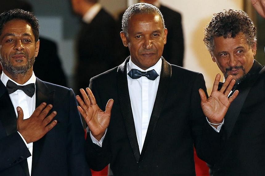 (From left) Tunisian actor Hichem Yacoubi, Mauritanian director Abderrahmane Sissako and Tunisian-born actor Abel Jafri pose as they arrive for the screening of their film Timbuktu at the Cannes Film Festival. The film is one of several to bring the 