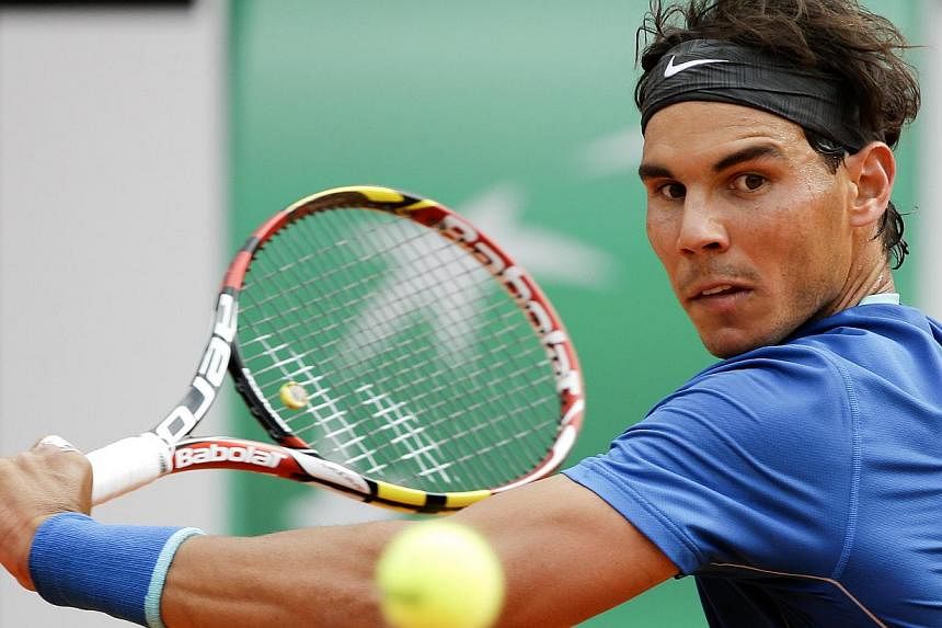 Rafael Nadal of Spain hits a return to Mikhail Youzhny of Russia during their men's singles match at the Rome Masters tennis tournament on May 15, 2014. -- PHOTO: REUTERS
