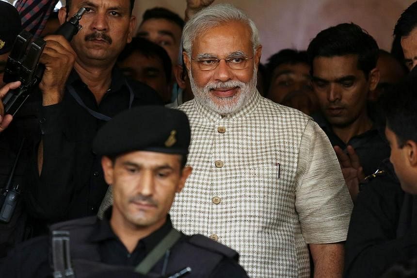 Bharatiya Janata Party's prime ministerial candidate and Gujarat Chief Minister Narendra Modi &nbsp;is escorted by security personnel at the party's state headquarters in Gandhinagar, Gujarat, on May 16, 2014. &nbsp;Election results, still being coun
