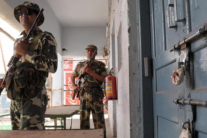 Indian paramilitary soldiers stand guard outside a sealed 'strong room' where Electronic Voting Machines (EVM) are kept, on the eve of the announcement of the results of the Lok Sabha - lower house -elections. India's triumphant right-wing opposition