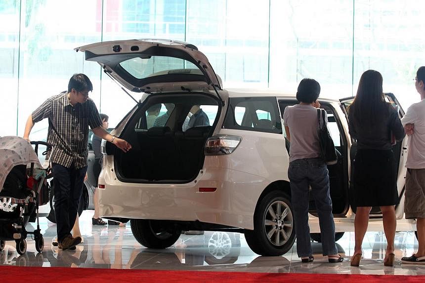 Potential car buyers and members of public at the Toyota showroom on March 17, 2013.&nbsp;Singapore is the most expensive place in the world to buy a car, according a survey by Deutsche Bank. -- ST FILE PHOTO:&nbsp;NEO XIAOBIN