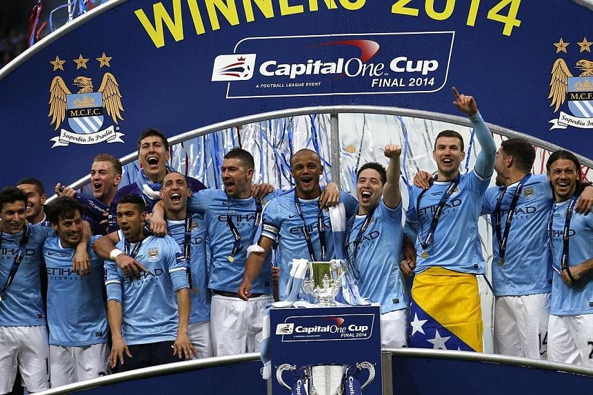 Manchester City celebrate winning their English League Cup final soccer match against Sunderland at Wembley Stadium in London on March 2, 2014. Manchester City and Paris Saint Germain have been given conditional fines of 60 million euros (S$102 milli