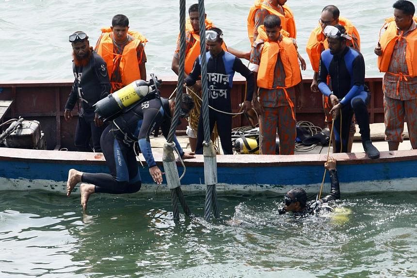 Rescue operations are undergoing for the sunken ferry MV Miraj 4 victims in the Megna River near Munshiganj, Bangladesh, on 16 May 2014.&nbsp;Divers battled on Friday to recover bodies trapped in the wreckage of a Bangladesh ferry that was sunk by a 