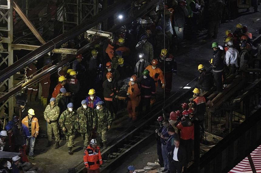 A body of miner is carried to an ambulance in Soma, a district in Turkey's western province of Manisa, on late May 16, 2014. The death toll in Turkey's worst ever mining disaster rose to 299 on Saturday as a new fire hampered rescue attempts, the ene