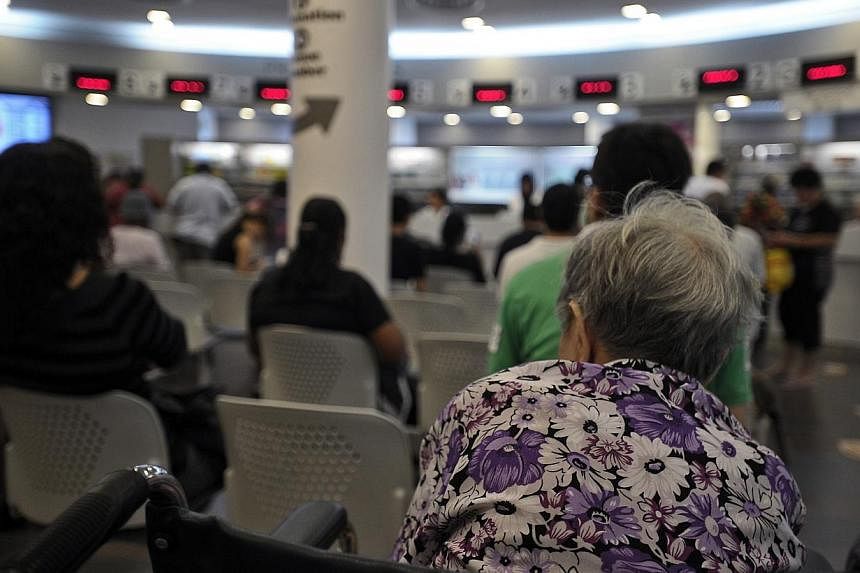 An elderly woman sits in the Pharmacy waiting area of Choa Chu Kang Polyclinic.&nbsp;The pioneer generation will receive more help with their outpatient healthcare needs than the poor now get. -- ST FILE PHOTO :&nbsp;JOSEPH NAIR