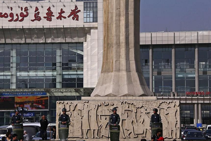 Armed police guard at the entrance of the South Railway Station, where three people were killed and 79 wounded in Wednesday's bomb and knife attack, in Urumqi, Xinjiang Uighur Autonomous region, on May 2, 2014.&nbsp;Chinese police have arrested seven