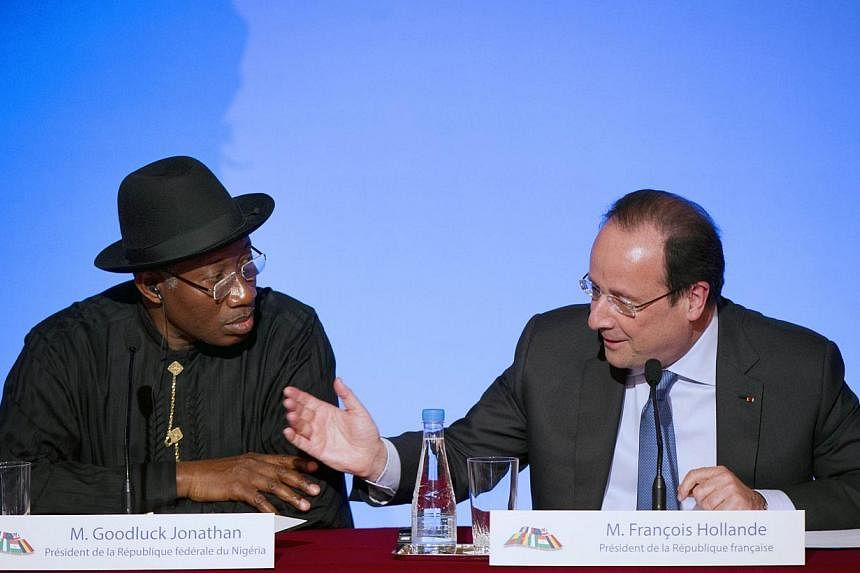Nigeria's president Goodluck Jonathan (left) and French president Francois Hollande give a press conference following a summit on the threat from Islamist sect Boko Haram at the Elysee palace, on May 17, 2014 in Paris. -- PHOTO: AFP
