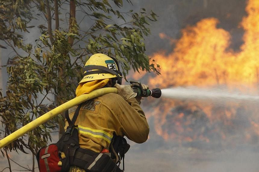 A firefighter hoses flames at the Cocos fire on May 15, 2014 in San Marcos, California. Fire agencies throughout the state are scrambling to prepare for what is expected to be a dangerous year of wildfires in this third year of extreme drought in Cal
