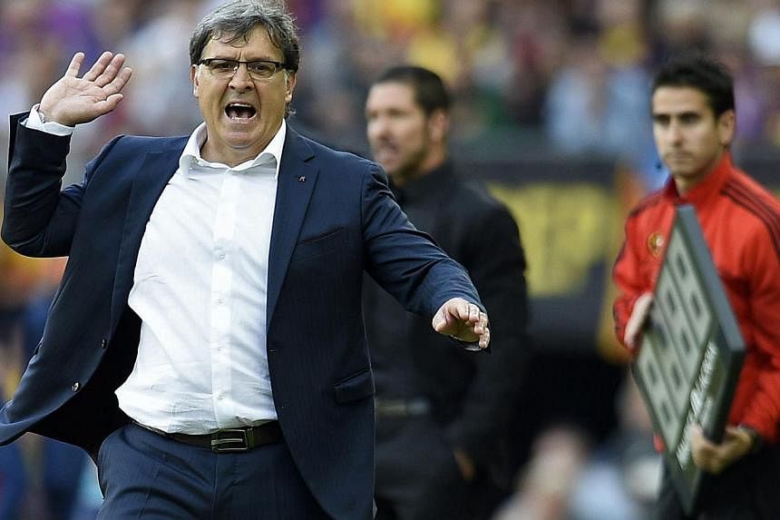 Barcelona's Argentinian coach Gerardo "Tata" Martino reacts during the Spanish league football match FC Barcelona vs Club Atletico de Madrid at the Camp Nou stadium in Barcelona on May 17, 2014. -- PHOTO: AFP