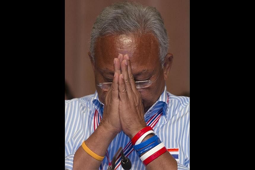 Thai anti-government protest leader Suthep Thaugsuban greeting his supporters at a meeting yesterday.