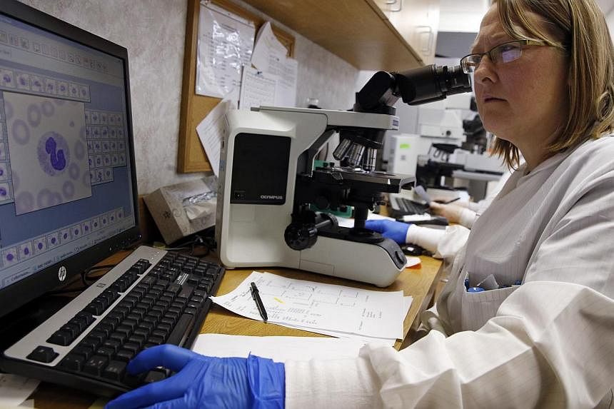 Shay Wilinski works in the Microbiology Lab at Community Hospital, where a patient with the first confirmed U.S. case of Middle East Respiratory Syndrome is in isolation, in Munster, Indiana, May 5, 2014. -- FILE PHOTO: REUTERS