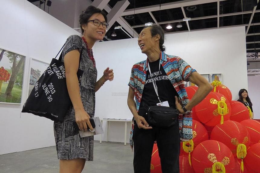 Singapore contemporary artist Lee Wen (right) talking to a visitor at his solo exhibition at the Art Basel Hong Kong.&nbsp;Speculation has been rife on Facebook that the artist was attacked after he expressed concern at an arts forum here about Tiana