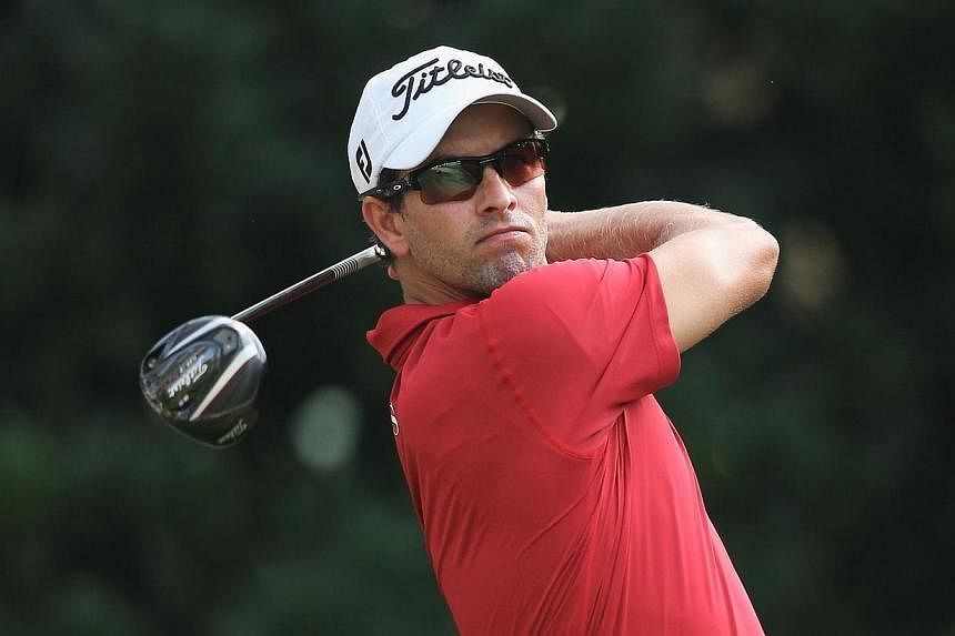 Australian Adam Scott has surpassed Tiger Woods as the No. 1 player on the official world golf rankings, seizing the top spot despite not playing this past week. -- FILE PHOTO: AFP