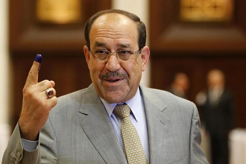 Iraq's Prime Minister Nuri al-Maliki shows his ink marked finger as he votes during parliamentary election in Baghdad April 30, 2014.&nbsp;Prime Minister Nuri al-Maliki's electoral bloc won the most seats in Iraq's parliamentary polls, results releas