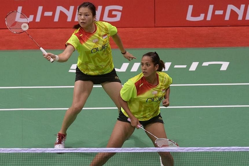 Lei Yao (top) and Shinta Mulia Sari of Singapore play a return shot to unseen Ye Na Jang and So Young Kim of Korea during their Uber Cup badminton match at The Siri Fort Stadium in New Delhi on May 18, 2014.&nbsp;The women's squad had gotten off to a