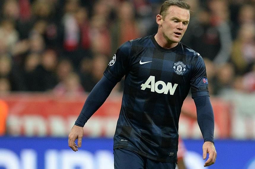 Manchester United's English striker Wayne Rooney reacts during the UEFA Champions League quarter-final second leg football match Bayern Munich vs Manchester United in Munich, southern Germany, on April 9, 2014. -- FILE PHOTO: AFP