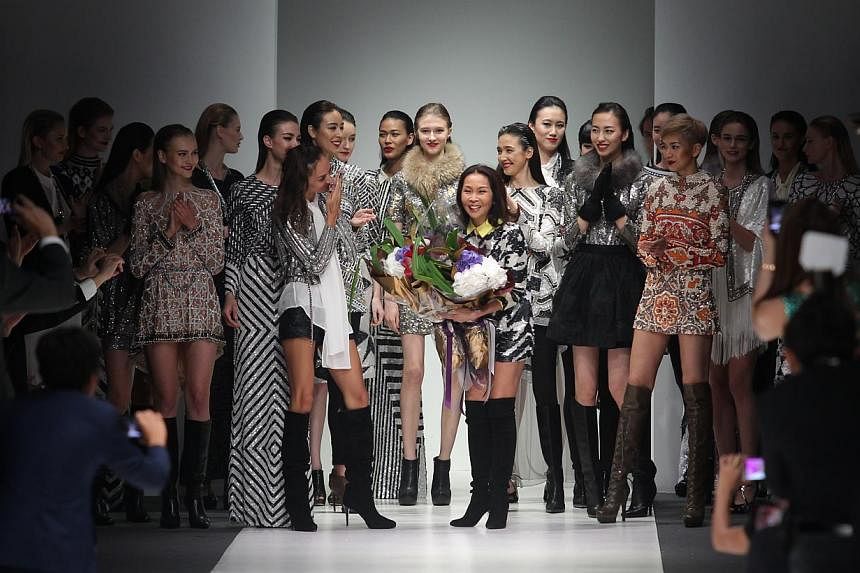 Khan’s (centre) creations on show at last week’s Audi Fashion Festival. -- ST PHOTO: ONG WEE JIN