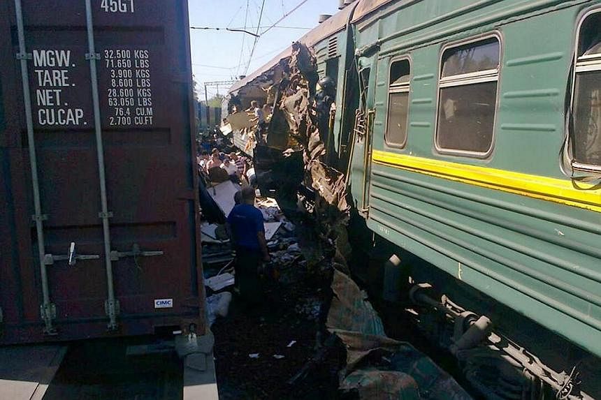 A handout photo provided on May 20, 2014, by the Russian Emergencies Ministry's Moscow Regional Centre shows the site of a collision of freight and passenger trains at the Bekasovo railway station, about 80 km (50 miles) south of Moscow. A&nbsp;freig