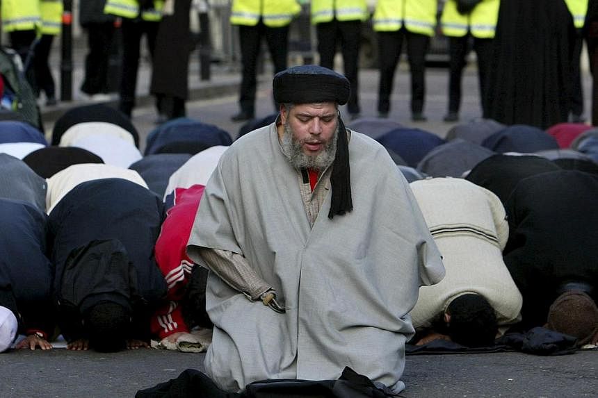 Muslim cleric, Abu Hamza al-Masri, is seen leading prayers outside the North London Central Mosque, in Finsbury Park, north London in this January 24, 2003 file photograph. -- PHOTO: REUTERS