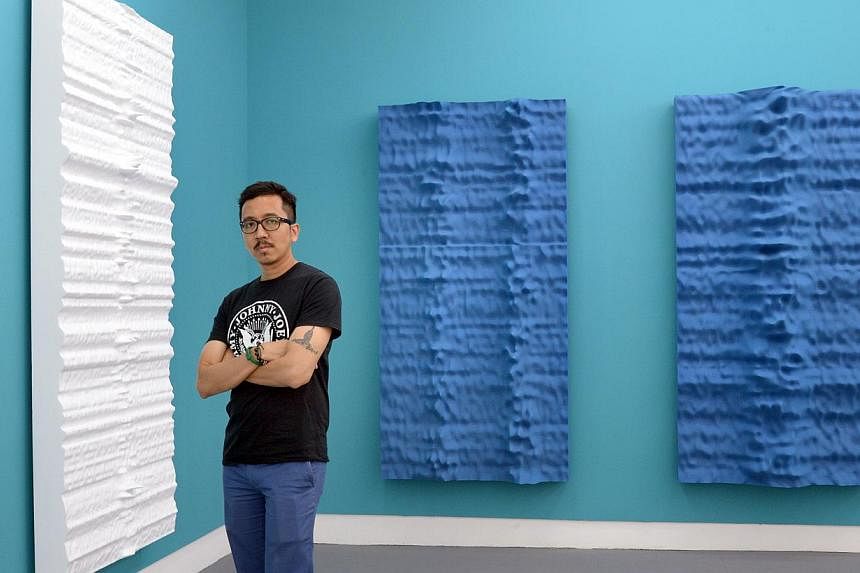 New and old in solo show: Singapore artist Jeremy Sharma with his paintings (from left) Parkes, Tahata and Ubuntu. -- ST PHOTO: LIM SIN THAI
