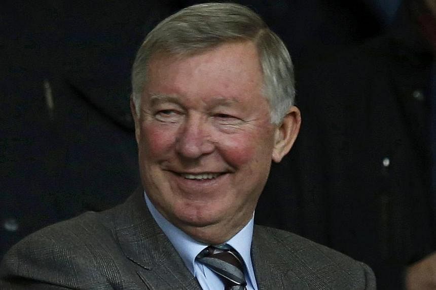 Former Manchester United manager Alex Ferguson takes his seat in the stand before their English Premier League soccer match against Manchester City at Old Trafford in Manchester, northern England on March 25, 2014. Sir Ferguson saluted Ryan Giggs' fa