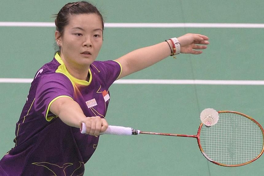 Fu Mingtian of Singapore plays a return to Maria Febe Kusumastuti of Indonesia during their Uber Cup badminton match at Siri Fort Stadium in New Delhi on May 20, 2014. -- PHOTO : AFP