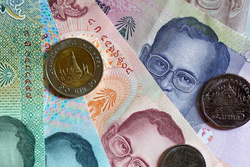 Thailand's baht fell against the dollar in early trade on May 20, 2014 after the imposition of martial law by the army, but it steadied later and dealers suspected that was due to intervention by the central bank. -- FILE PHOTO: BLOOMBERG
