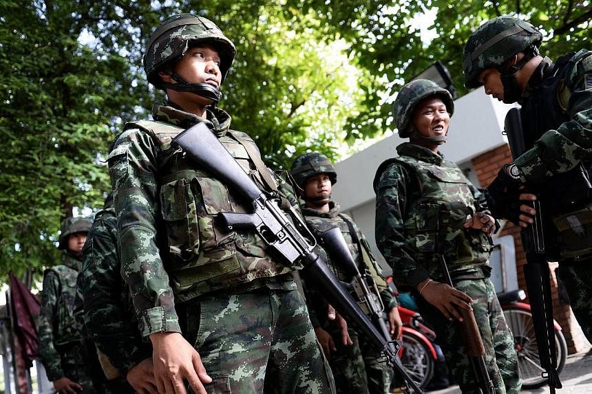 Thai soldiers stand outside the Government Public Relations Department after martial law was imposed in Bangkok on May 20, 2014. -- PHOTO: AFP
