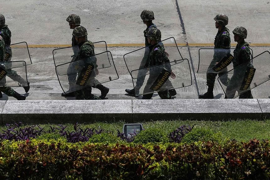 Thai soldiers walk inside a compound of the Army Club after the army declared martial law nationwide to restore order, in Bangkok on May 20, 2014. -- PHOTO: REUTERS