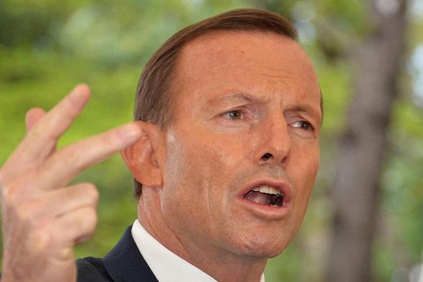 Australian Prime Minister Tony Abbott came under fire on Wednesday, May 21, 2014, for winking when he took a call on air from a distressed pensioner who said she worked on a sex phone line to pay the bills. -- PHOTO: AFP