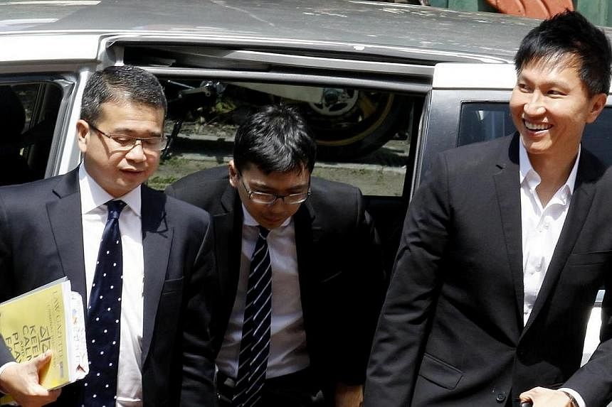 City Harvest Church founder Kong Hee (right) arriving at court with lawyer Edwin Tong (left) and an unidentified lawyer on May 5, 2014. The City Harvest Church trial resumed briefly on May 21 as one of the defence lawyers asked the court to refer two
