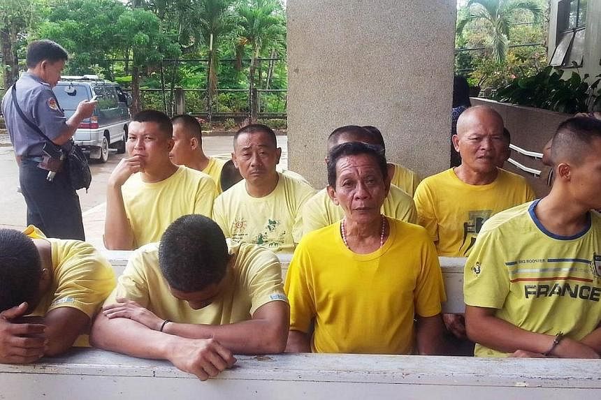 Arrested Chinese fishermen sit with other suspects on charges of illegal fishing while waiting for their arraignment at a court in Puerto Princesa in Palawan island on May 21, 2014.&nbsp;Nine Chinese fishermen arrested by Philippine authorities in di