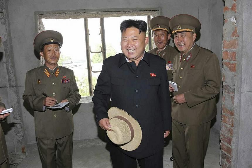 An undated picture released by the North Korean Central News Agency (KCNA) on May 21 2014 shows North Korean leader Kim Jong Un (centre) touring an apartment construction site in Pyongyang, North Korea. North Korean leader Kim Jung Un has sought to r
