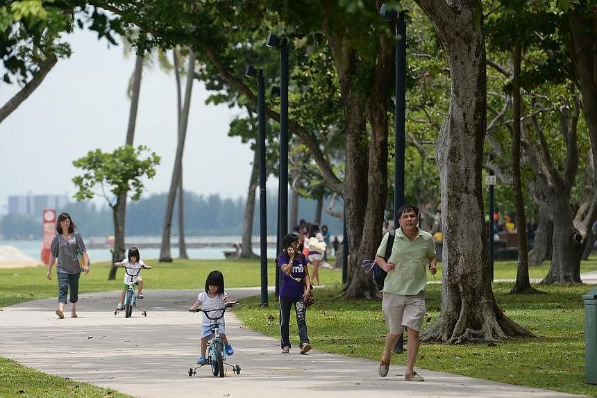 Parents spending time with their children at East Coast Park. -- ST PHOTO: JAMIE KOH