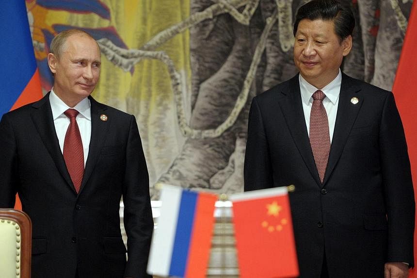 Russian President Vladimir Putin (L) and Chinese President Xi Jinping (R) attend a ceremony of the signing of a China-Russia gas deal in Shanghai, China, on 21 May 2014. -- PHOTO: EPA