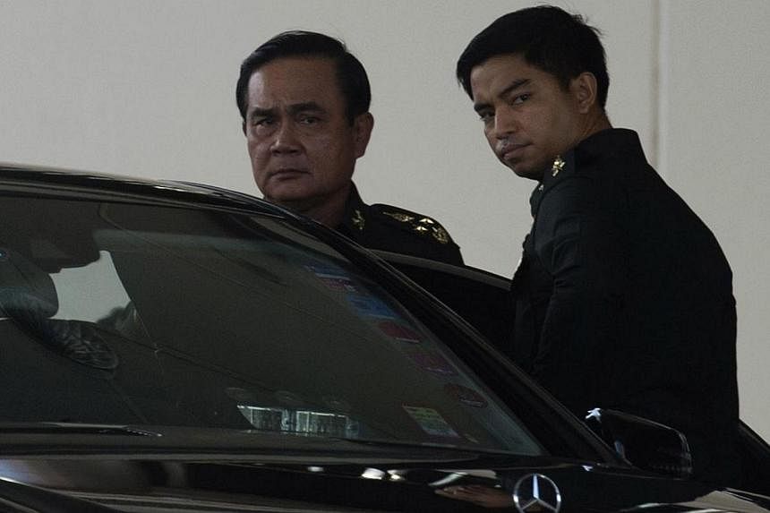 Thailand's army chief Prayut Chan-O-Cha (left) leaves after meeting with anti-government and pro-government leaders at the Army Club in Bangkok on May 22, 2014. -- PHOTO: AFP