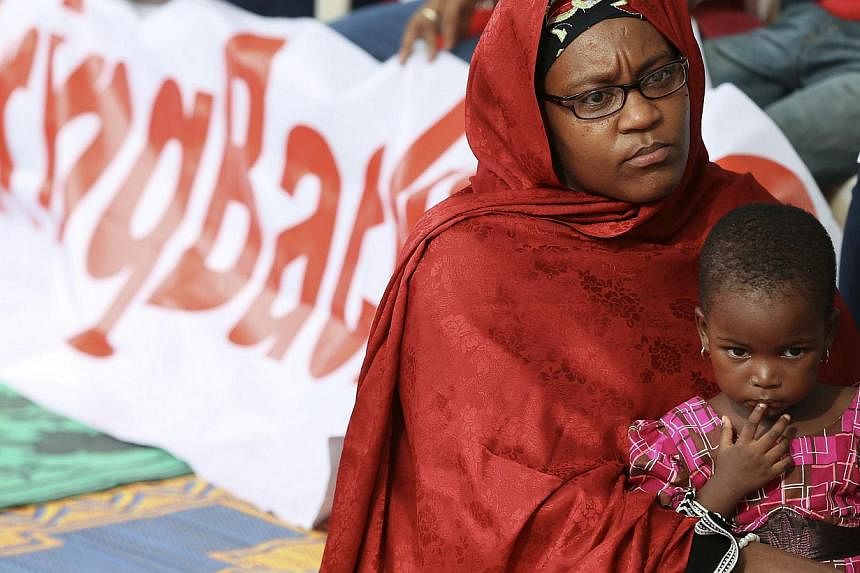 A mother and her daughter join protesters in a sit-in protest demanding the release of abducted secondary school girls in the remote village of Chibok, opposite Maitama park, in Abuja on May 10, 2014. The United States deployed 80 military personnel 