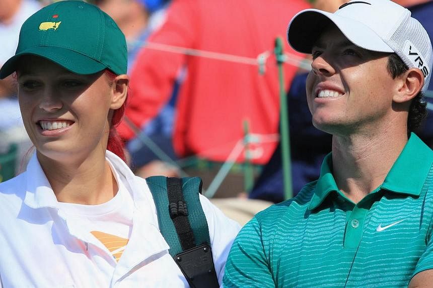 Rory McIlroy alongside his then girlfriend Caroline Wozniacki during the 2014 Par 3 Contest prior to the start of the 2014 Masters Tournament at Augusta National Golf Club on April 9, 2014 in Augusta, Georgia. -- PHOTO: AFP