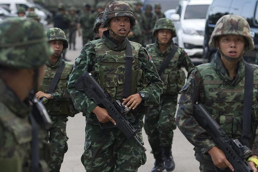 Thai soldiers patrol after army chief General Prayut Chan-O-Cha met with anti-government and pro-government leaders at the Army Club in Bangkok on May 22, 2014. -- PHOTO: AFP