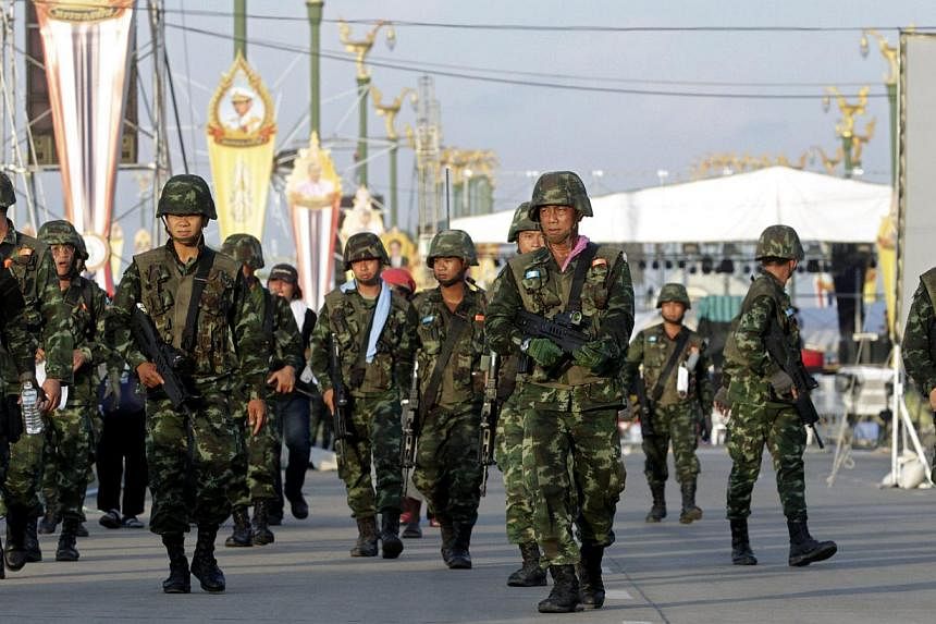 Thai soldiers patrol to clear Red Shirt pro-government supporters after the army declared coup at the rally site on the outskirts of Bangkok, Thailand, on May 22, 2014. -- PHOTO: EPA