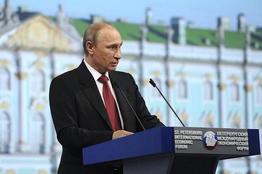Russia's President Vladimir Putin speaks during a session of the St Petersburg International Economic Forum 2014 in St Petersburg on May 23, 2014.&nbsp;Mr Putin said on Friday, May 23, 2014, he was upbeat on the prospects for resolving the crisis in 